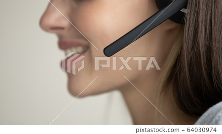 Female call center agent talk online using headset 64030974