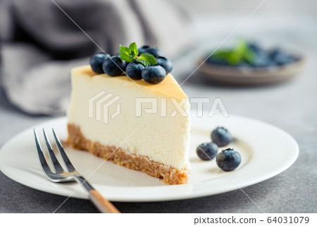 Cheesecake with blueberries on white plate Cheesecake with blueberries on white plate 64031079