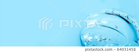 Hyaluronic acid cosmetic gel. Gel texture with bubbles on a blue background. Transparent smear of gel Banner 64031458