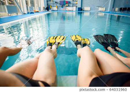 Female group at the poolside, feet in flippers Female group at the poolside, feet in flippers 64031960