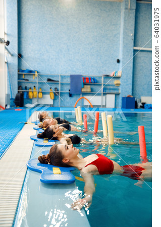 Female swimmers, aqua aerobics at the poolside Female swimmers, aqua aerobics at the poolside 64031975