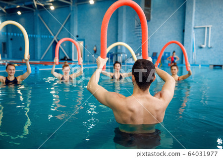 Instructor and female group, training in the pool 64031977