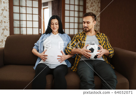 Husband with ball and his pregnant wife with belly Husband with ball and his pregnant wife with belly 64032071