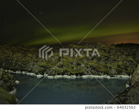 Stars and northern lights above the volcanic rocks 64032562