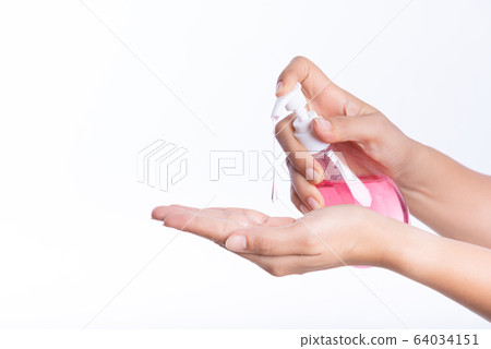 Female hands using wash hand sanitizer gel pump Female hands using wash hand sanitizer gel pump 64034151