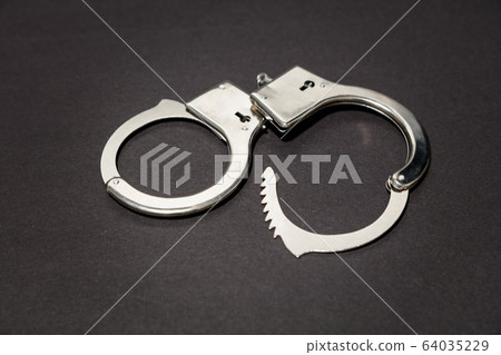 Pair of metal handcuffs 64035229