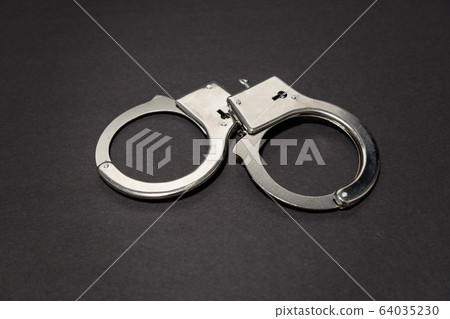 Pair of metal handcuffs 64035230