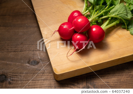 Radish on a cutting board 64037240