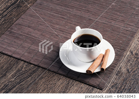 Cup of black coffee on wooden table 64038043