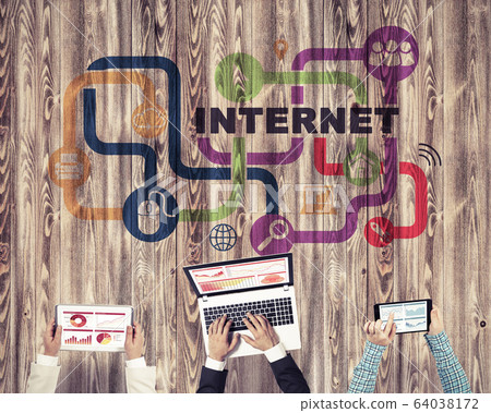 Top view of businesspeople sitting at table and using gadgets 64038172