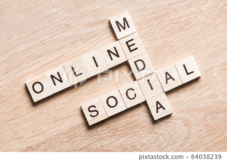 Conceptual media keywords on table with elements of game making crossword Conceptual media keywords on table with elements of game making crossword 64038239