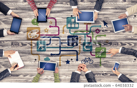 Top view of businesspeople sitting at table and using gadgets Top view of businesspeople sitting at table and using gadgets 64038332