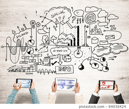 Top view of businesspeople sitting at table and using gadgets Top view of businesspeople sitting at table and using gadgets 64038424