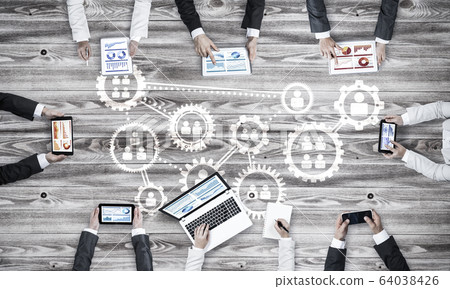 Top view of businesspeople sitting at table and using gadgets Top view of businesspeople sitting at table and using gadgets 64038426