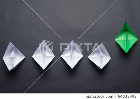 Row of paper ships on black background 64038492