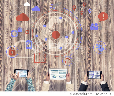 Top view of businesspeople sitting at table and using gadgets Top view of businesspeople sitting at table and using gadgets 64038603