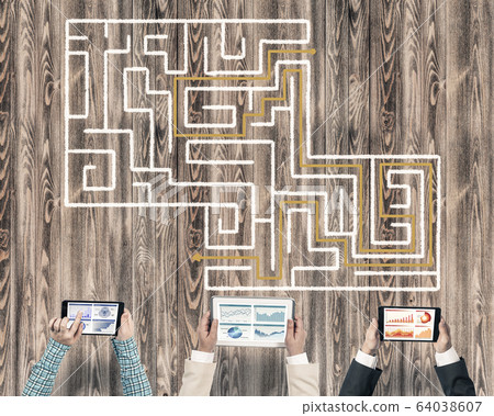Top view of businesspeople sitting at table and using gadgets Top view of businesspeople sitting at table and using gadgets 64038607