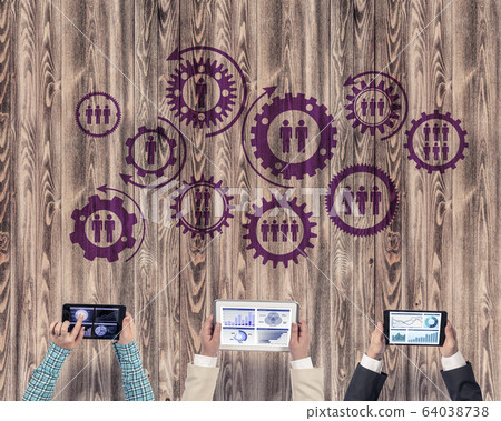 Top view of businesspeople sitting at table and using gadgets Top view of businesspeople sitting at table and using gadgets 64038738