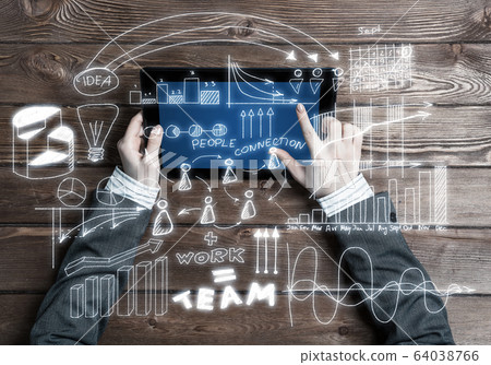 Concept of business strategy and planning with tablet on wooden table Concept of business strategy and planning with tablet on wooden table 64038766
