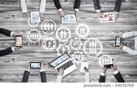 Top view of businesspeople sitting at table and using gadgets Top view of businesspeople sitting at table and using gadgets 64038769