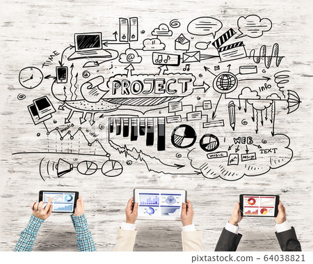 Top view of businesspeople sitting at table and using gadgets Top view of businesspeople sitting at table and using gadgets 64038821