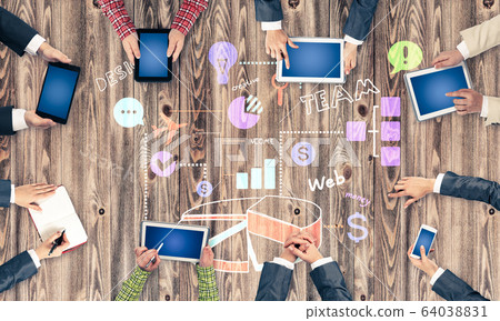 Top view of businesspeople sitting at table and using gadgets Top view of businesspeople sitting at table and using gadgets 64038831