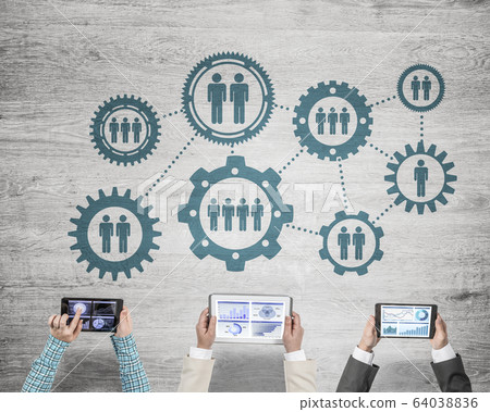 Top view of businesspeople sitting at table and using gadgets Top view of businesspeople sitting at table and using gadgets 64038836