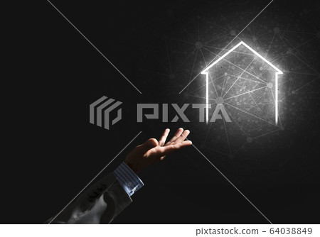 Conceptual image with hand pointing at house or main page icon on dark background 64038849