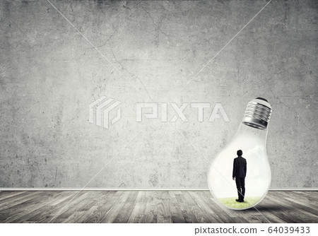 Businessman trapped in bulb 64039433