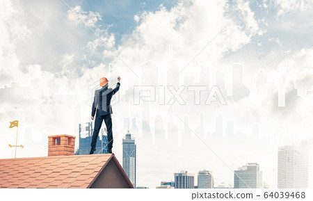 Man architect draw silhouette of modern city on blue sky. Mixed 64039468