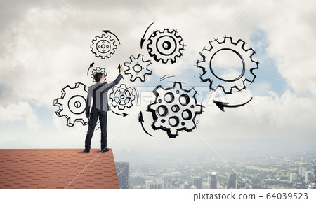 Mister boss on brick roof standing with back and draw teamwork c 64039523