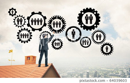 Businessman on house roof presenting teamwork and connection con Businessman on house roof presenting teamwork and connection con 64039603
