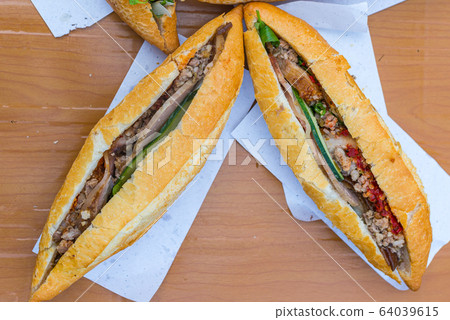 Vietnamese styled sandwich stuffed with meat and salad- Banh Mi  64039615