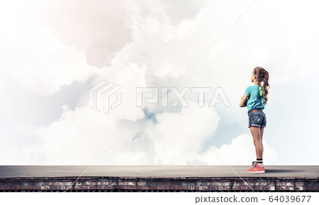 Concept of careless happy childhood with girl looking far away Concept of careless happy childhood with girl looking far away 64039677