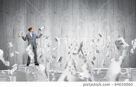 Businessman standing with megaphone. 64039860