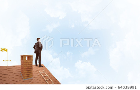 Mister boss on brick roof with arms akimbo. Mixed media Mister boss on brick roof with arms akimbo. Mixed media 64039991