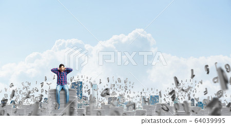 Attractive man sitting on pile of paper documents. Attractive man sitting on pile of paper documents. 64039995