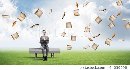 Young businessman or student studying the science and books fly around Young businessman or student studying the science and books fly around 64039996