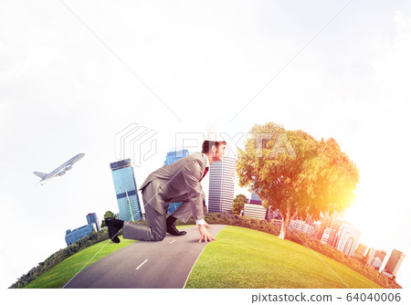 King businessman in elegant suit running on green globe with mod 64040006