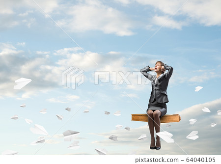 Stressful woman sitting on sitting on big book Stressful woman sitting on sitting on big book 64040105