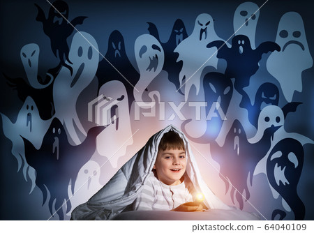 Smiling boy with flashlight under blanket Smiling boy with flashlight under blanket 64040109