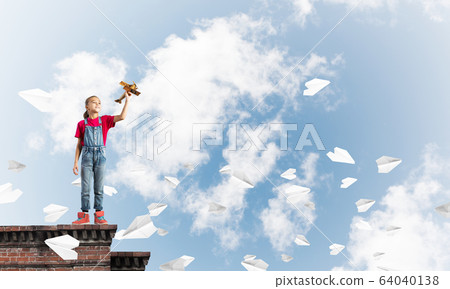 Concept of careless happy childhood with girl dreaming to become pilot Concept of careless happy childhood with girl dreaming to become pilot 64040138