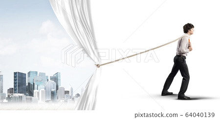 Young man opening white curtain and presenting modern city landscape Young man opening white curtain and presenting modern city landscape 64040139
