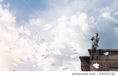 Young man on building edge do not want to see anything Young man on building edge do not want to see anything 64040192