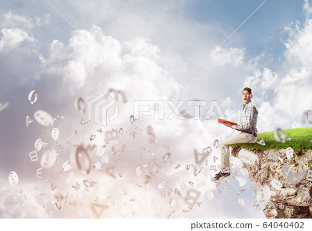 Student guy in suit with book in hands preparing for exam 64040402