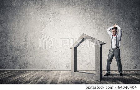 Stone home silhouette in empty room as symbol for real estate insurance 64040404