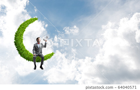 Businessman or manager in blue day sky announcing something in loudspeaker Businessman or manager in blue day sky announcing something in loudspeaker 64040571