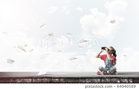 Concept of careless happy childhood with girl of school age look 64040589