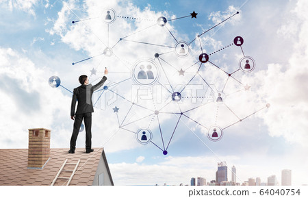 Businessman on house roof presenting networking and connection concept. Mixed media 64040754