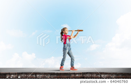 Concept of careless happy childhood with girl exploring this world 64040760